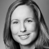 Nicole Horn Eine Frau mit langen Haaren lächelt in die Kamera. Das Bild ist in schwarz-weiß fotografiert.